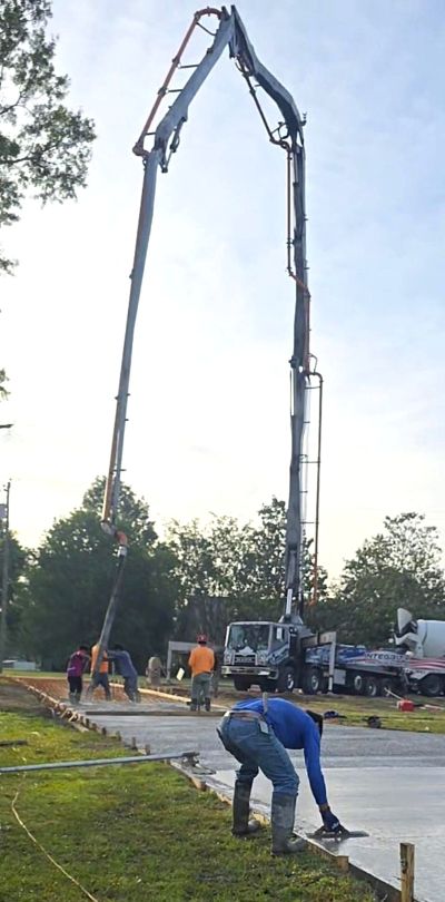 Concrete bumping boom filling a driveway form